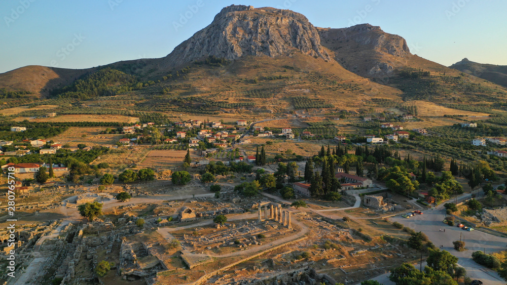Aerial drone photo of iconic archaeological site of Ancient Corinth featuring temple of Apollo built in the slopes of Acrocorinth, Peloponnese, Greece