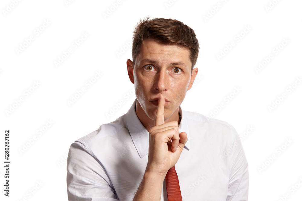 Portrait of a young brunet man posing in a studio isolated over a white background. Portrait of a young brunet man posing in a studio isolated over a white background.