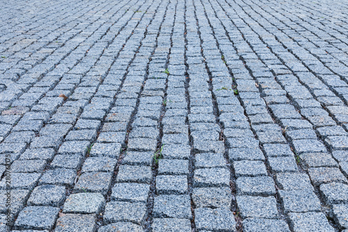 The gray pavement of square stones background or texture