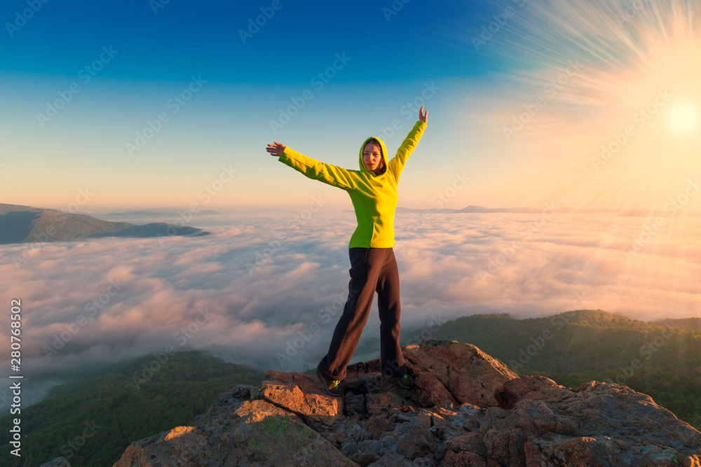 A woman on top mountain, summer cloudscape A woman on top mountain, summer cloudscape