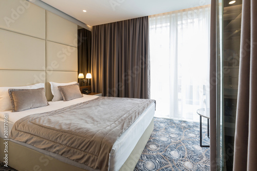 Interior of a luxury hotel double bed bedroom © rilueda