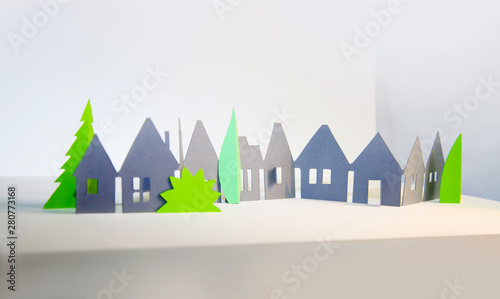 Little town houses in raw. City, property and house buying concept. Paper cut design background.
