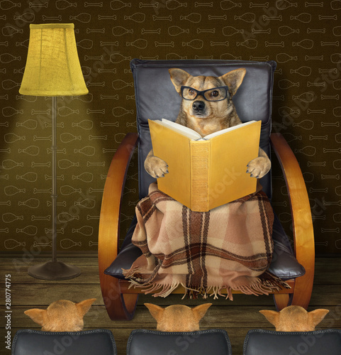 The dog  in the black leather armchair near the torchere is reading a book to puppies in the living room. photo