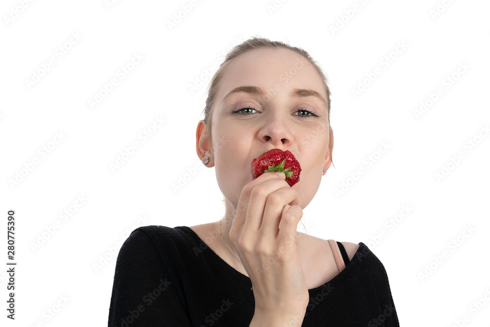 young woman is enjoying to eat a strawberry young woman is enjoying to eat a strawberry