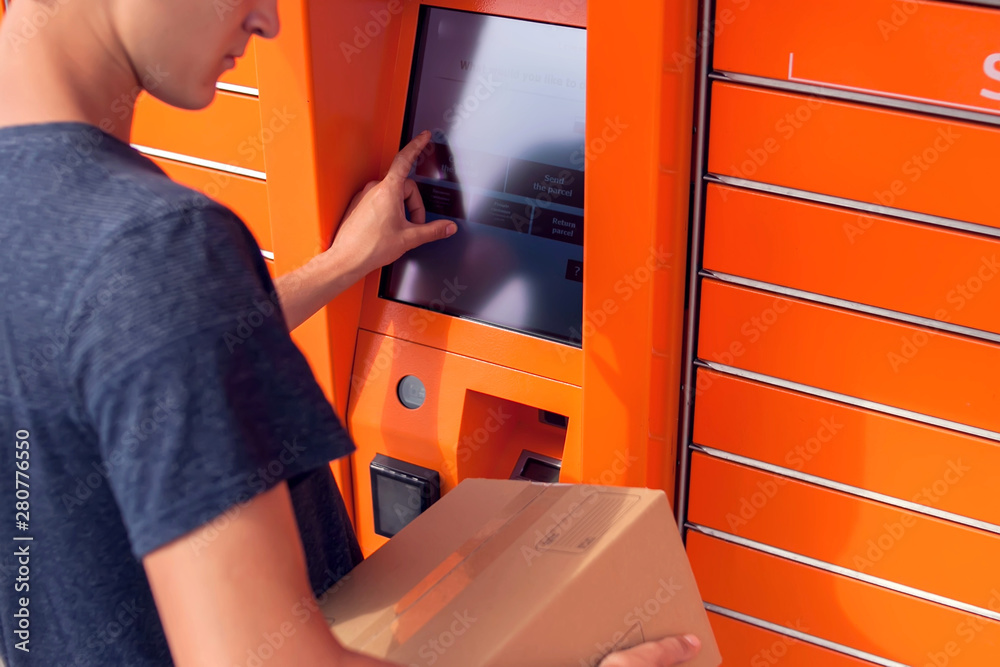 Client using automated self service post terminal machine or locker to deposit a parcel for storage Client using automated self service post terminal machine or locker to deposit a parcel for storage