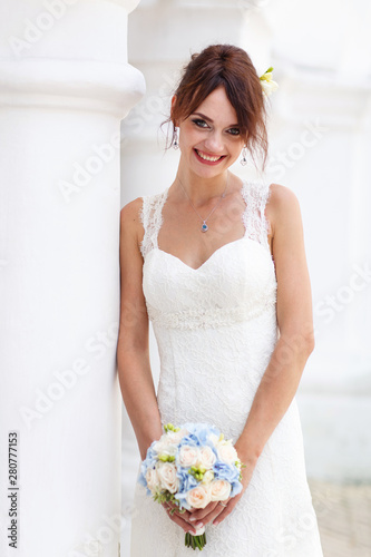 Portrait of a happy smiling bride in white marriage dress.