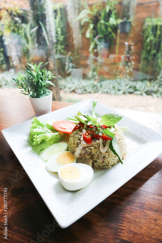 stir-fried rice with green curry and boiled egg ,thai  food photo