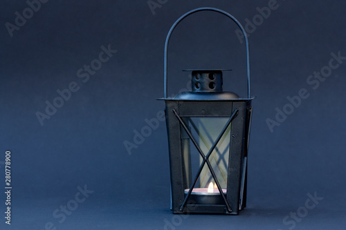 Black lantern on dark blue background.