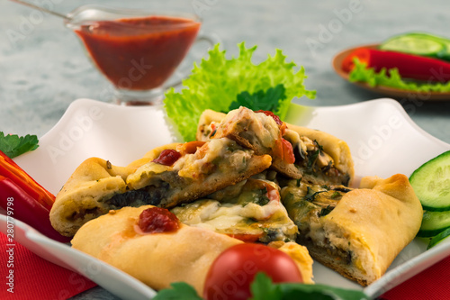 Slices of mini pizza with mushrooms and cheese. Close-up. Tasty fast food. Traditional Italian recipe.