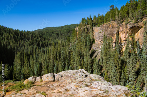 Red rock sandstone canyon wall and rock outcropping above the Piedra River near Pagosa Springs, Colorado photo