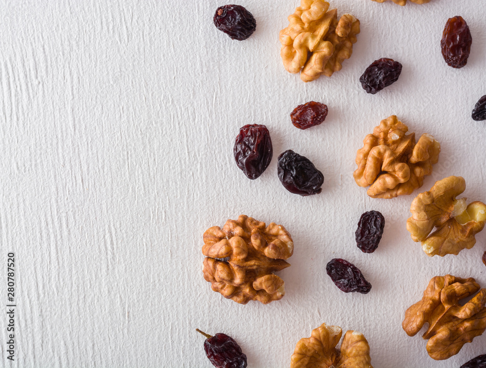 custom made wallpaper toronto digitalA variety of peeled walnuts and raisins on a white wooden background. View from above. Plenty of space for text.