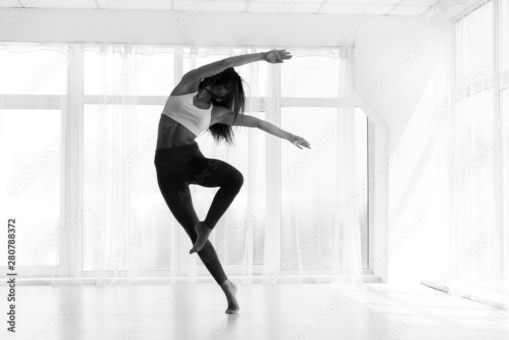 © Prostock-studio - Young Woman Training Contemp In Modern Dance Studio. Black And W © Prostock-studio - Young Woman Training Contemp In Modern Dance Studio. Black And W