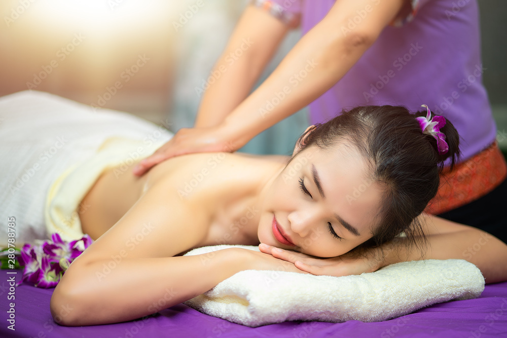 Body care. Relaxed woman enjoying back massage Stock Photo by