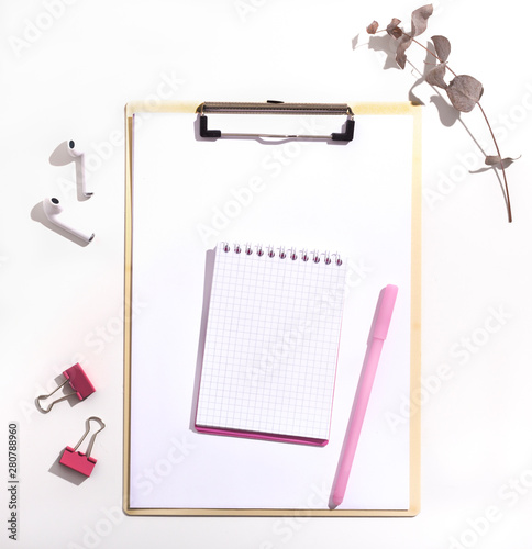 Notepad with blank space and pink pen on white background