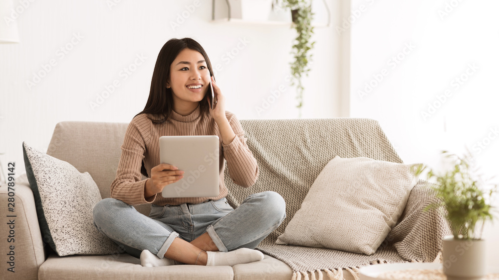 Girl Calling Friend, Using Digital Tablet at Home Girl Calling Friend, Using Digital Tablet at Home