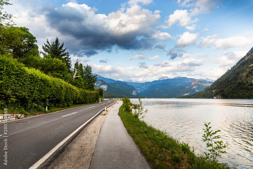 Fototapeta premium Road along the mountain lake. Summer evening. Austrian Alps.
