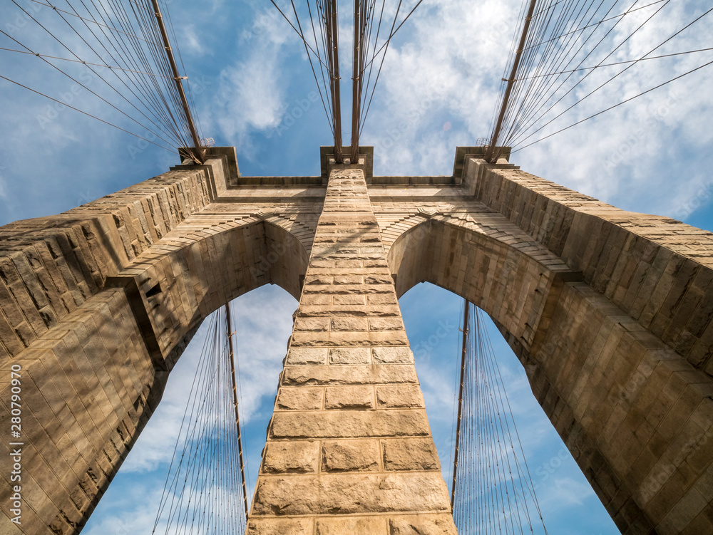 Obraz premium Wide Angle View of the top one of Brooklyn Bridge Brick Towers With Mostly Clear Skies