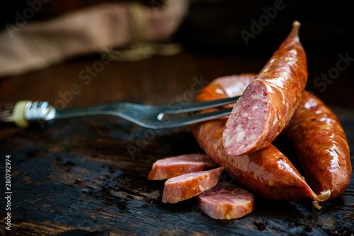 Bavarian smoked sausages from pork cut on a wooden Board. Rustic style photo