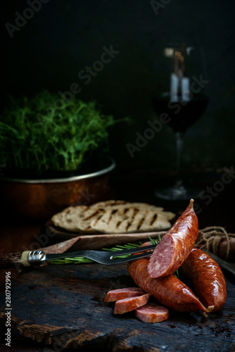 Bavarian smoked sausages from pork cut on a wooden Board. Rustic style
