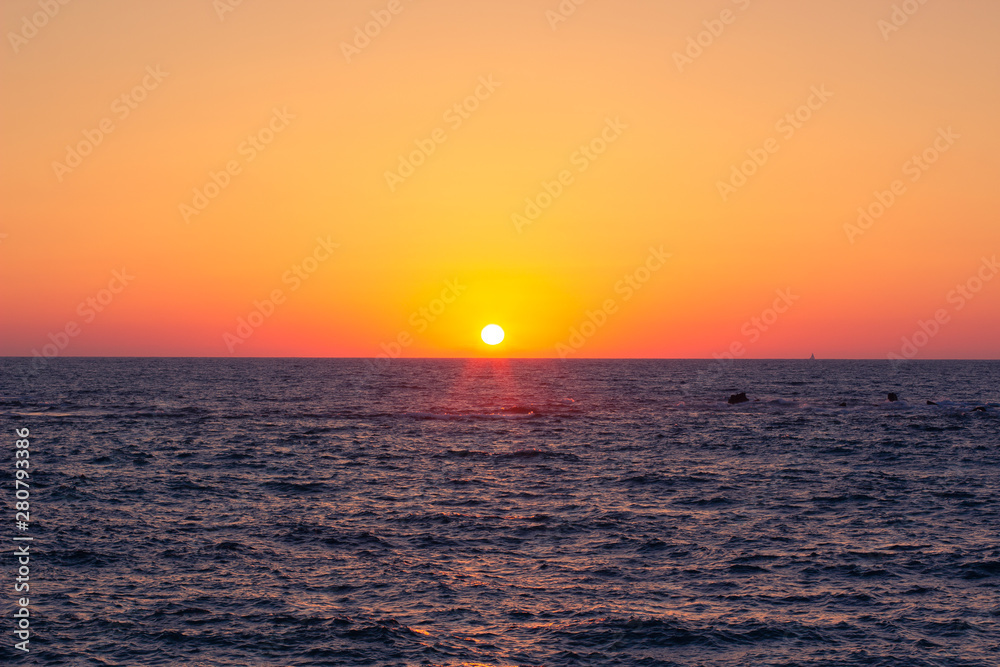 idyllic peaceful beautiful orange sunset above Mediterranean sea horizontal simple nature background wallpaper scenic landscape pattern with empty space for copy or text