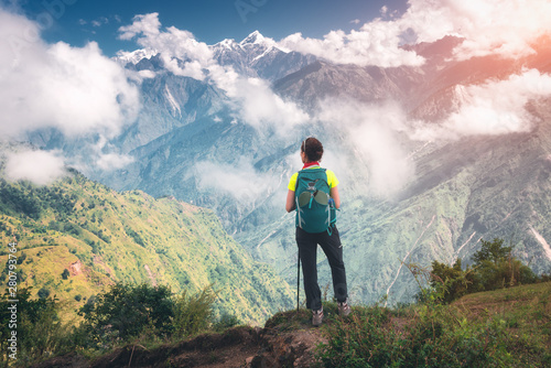 Standing young woman with b...
