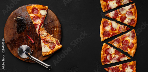 Fresh pepperoni pizza slices in row on dark background
