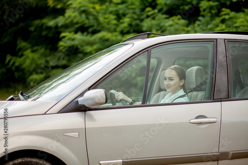 Pretty, young woman driving a car -Invitation to travel. Car rental or vacation © volody10