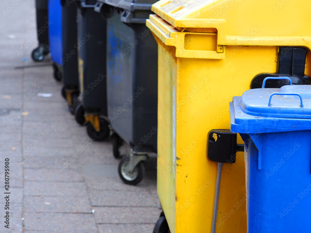 Multicolored trash cans on the street Multicolored trash cans on the street