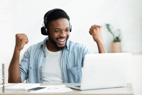 African American male freelancer celebrating completing the project photo