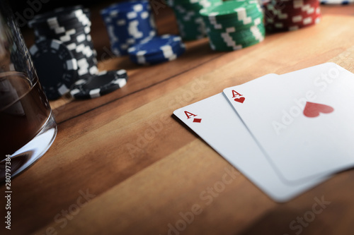 Poker Chips with Playing Cards on a Beautiful Wooden Table