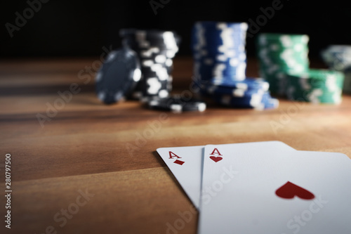 Poker Chips with Playing Cards on a Beautiful Wooden Table