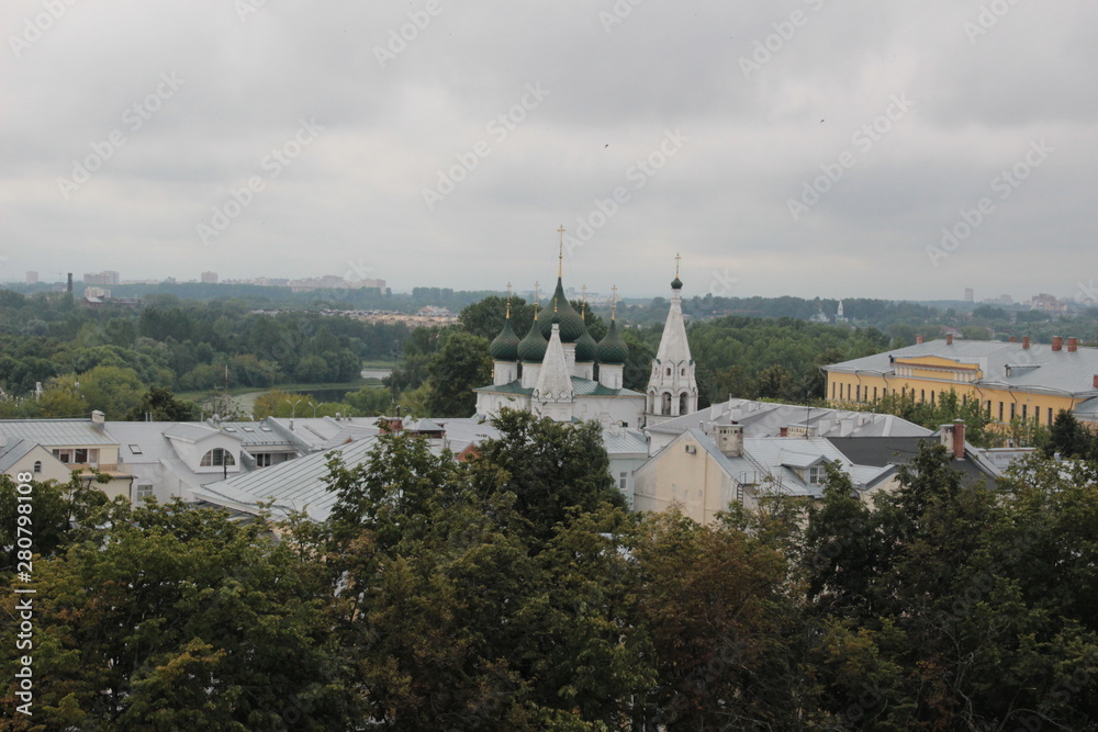 Top view on summer Yaroslavl historical center with church domes and green trees in cloudy day