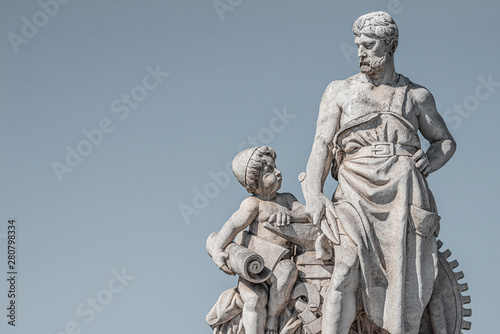 Sculpture of engineer and his scholar on Zoll Bridge in Magdeburg downtown at smooth gradient background  Germany  details  closeup