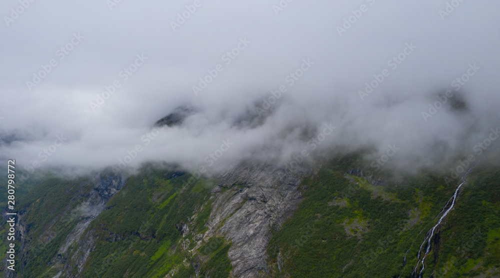 The top part of the famous road Trollstigen in Norway, with beautiful clouds in the background with amazing mountains. July 2019