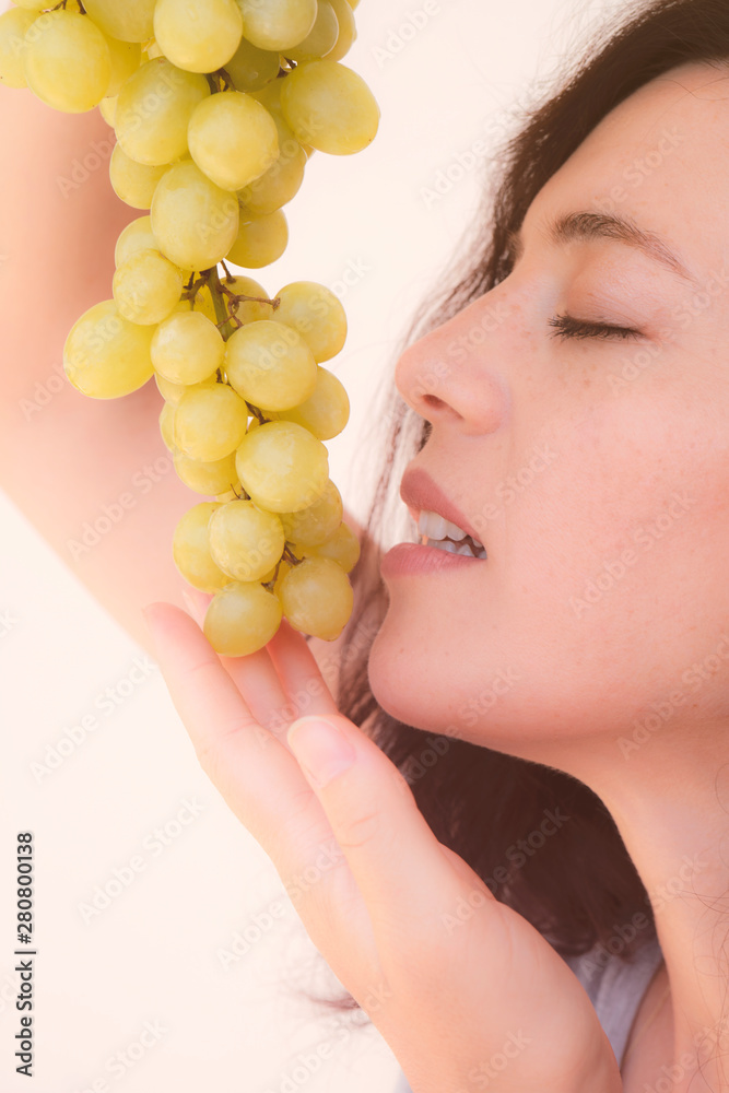 Beautiful young woman with green grape. Isolated white background Beautiful young woman with green grape. Isolated white background