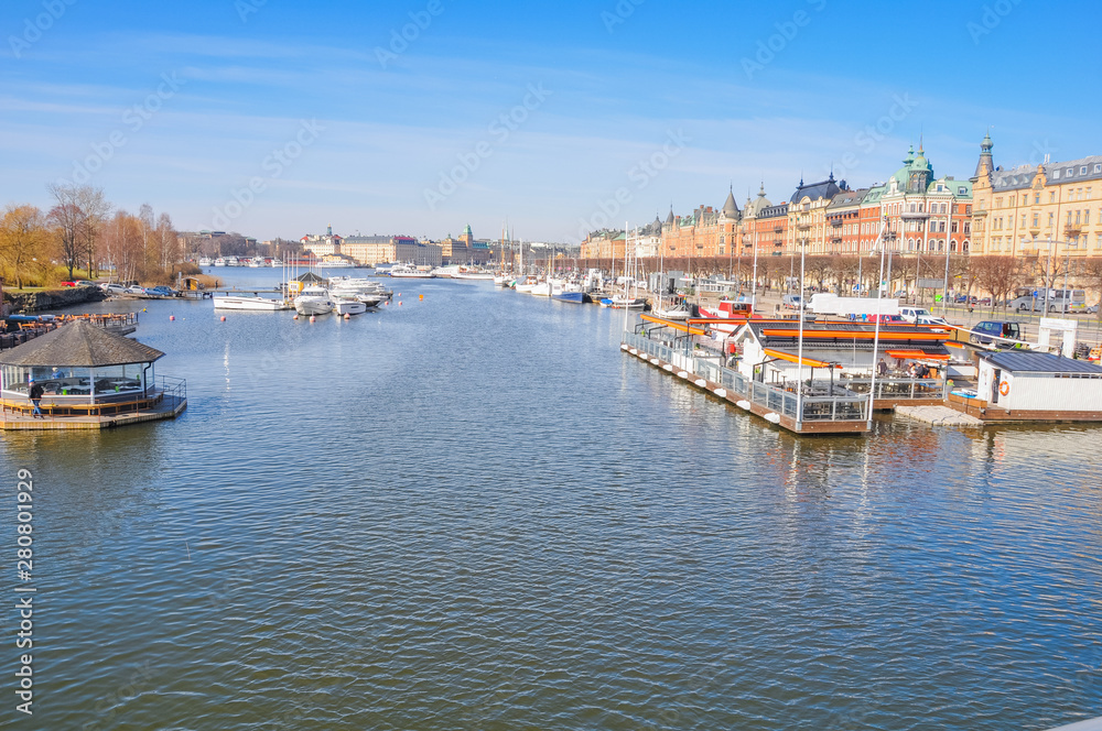 Stockholm Sweden Canal with boats and historic buildings in the background.