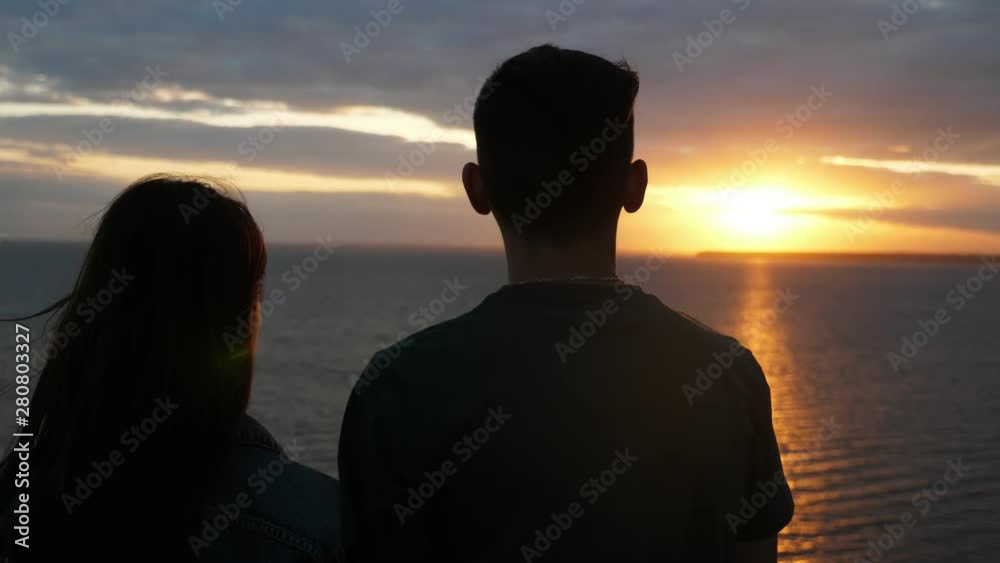 Cheery boy and his beauty looking at the Black Sea waves at sunset in slo-mo Cheery boy and his beauty looking at the Black Sea waves at sunset in slo-mo