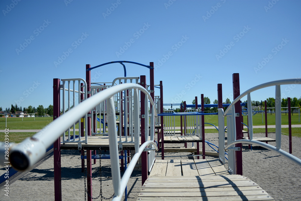 Colourful playground bridge and hand rail in school yard.