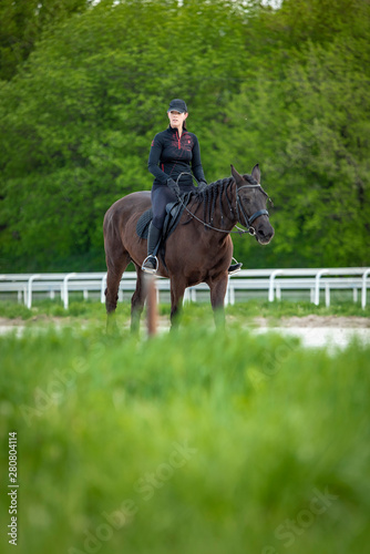 Young jockey woman horsebacking © Teodor Lazarev