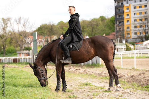 Young guy riding his favorite horse © Teodor Lazarev