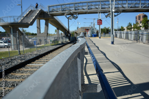 Pedestrian transit train track line at city station. © Jeff