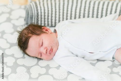 first day of the child at home. Newborn baby sleep first days of life. Cute little newborn child sleeping peacefully