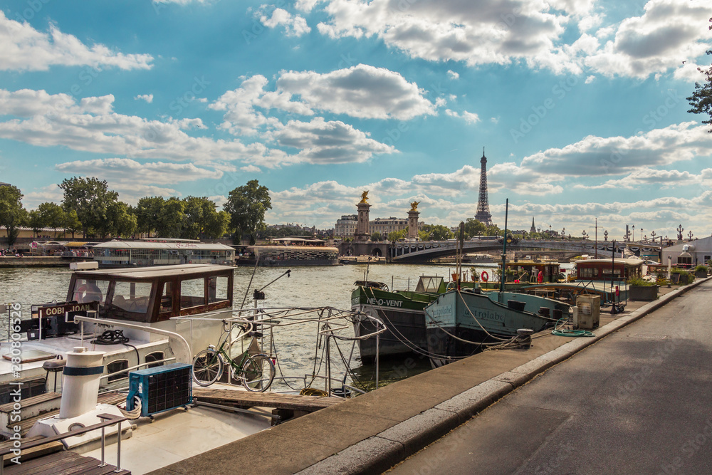 The Seine river with boats near Pont de la Concorde and Tour Eiffel in the background