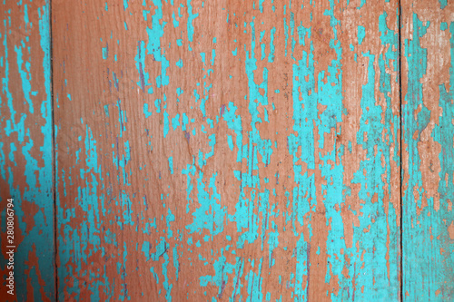 blue and red peeled wooden wall of the house as a background texture
