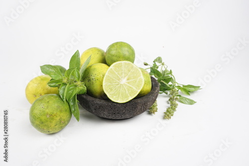 limes and mint on white background