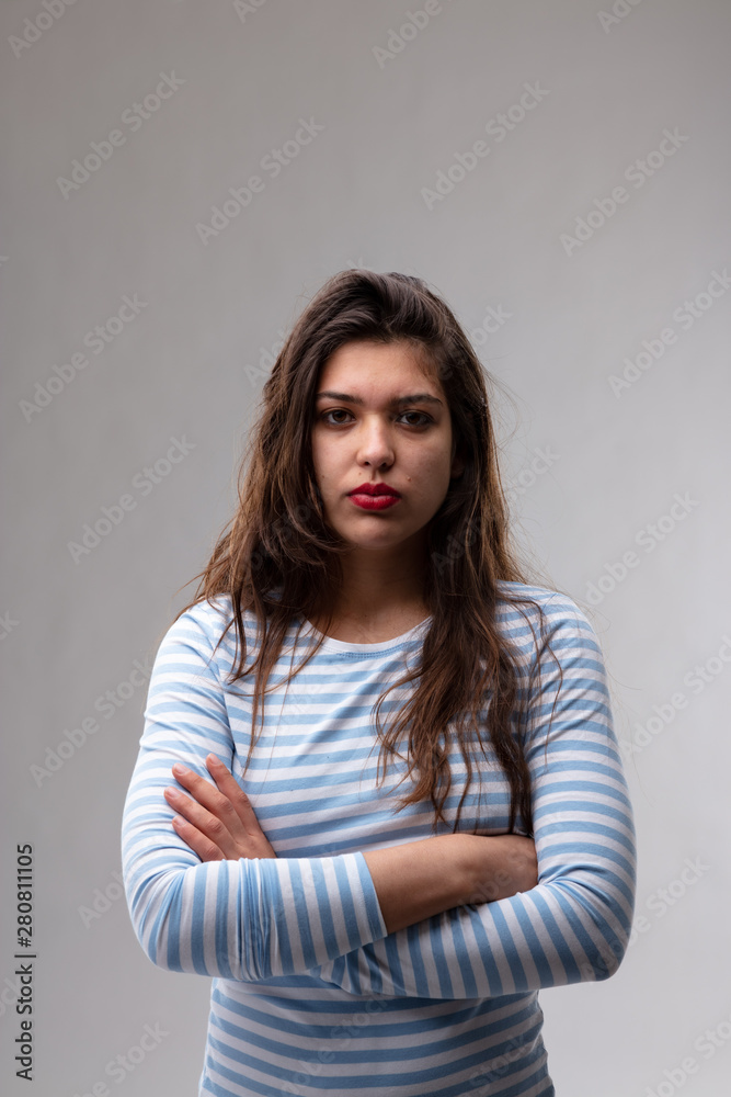 Serious young woman with an enigmatic expression Serious young woman with an enigmatic expression