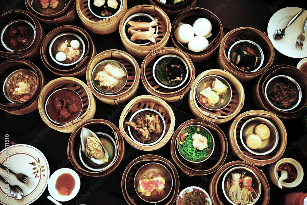 Various chinese steamed dumpling in bamboo basket set on table 