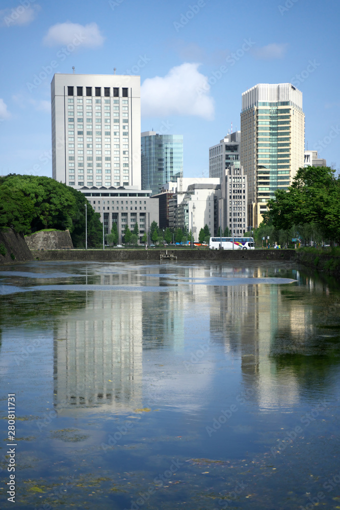 Tokyo,Japan-July 27,2019: Water in moat reflecting buildings in Tokyo