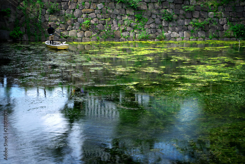Tokyo,Japan-July 27,2019: Water in moat full of waterweed and algae in Tokyo