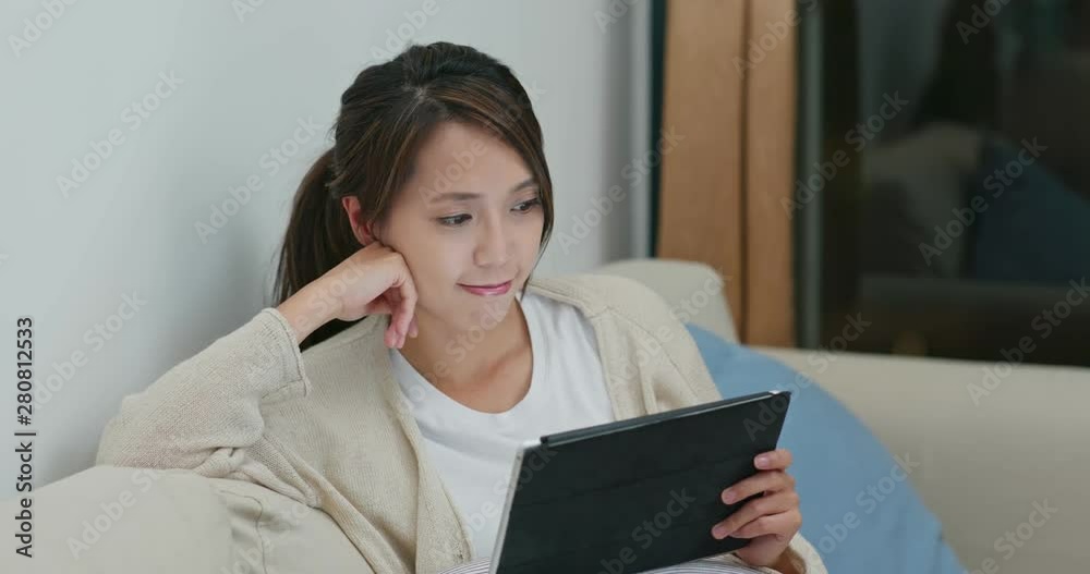 Woman watch on digital tablet computer at home Woman watch on digital tablet computer at home